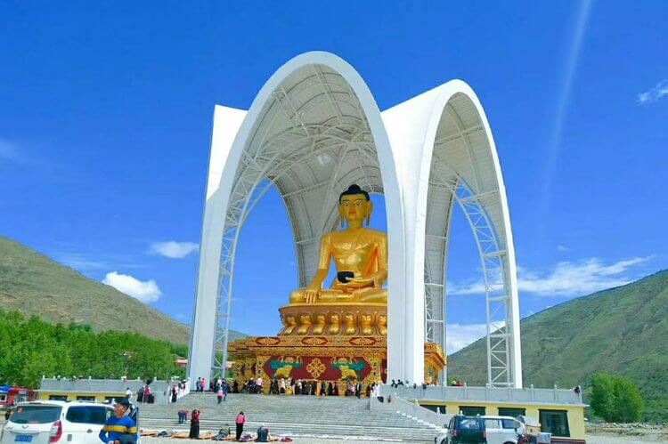 Buddha statue in Drago County being circumambulated by local Tibetans