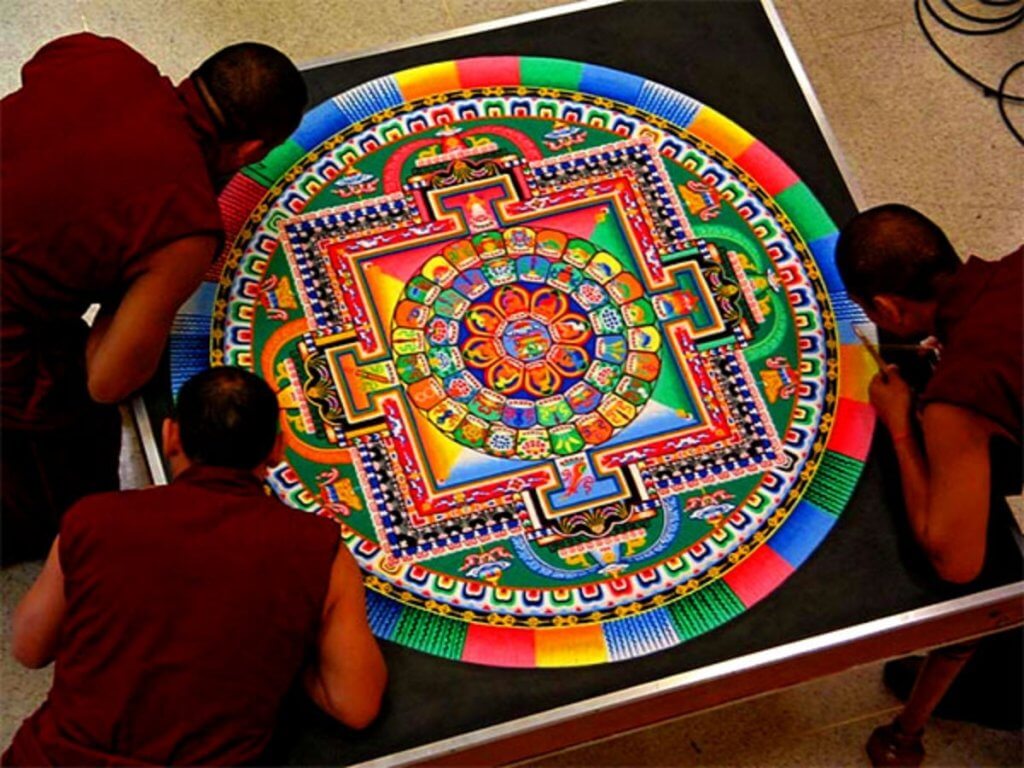 Buddhist monks constructing a sand mandala Image source: faena.com