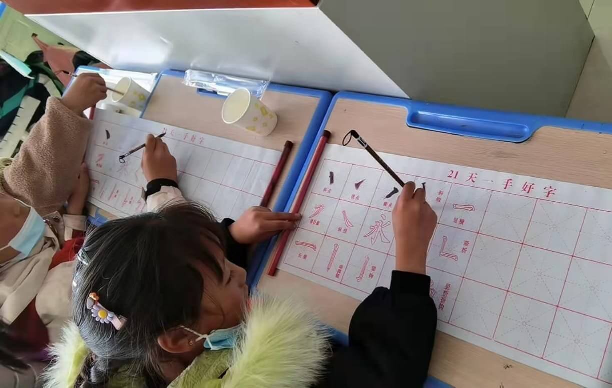 Students learning Chinese writing in a school in Golog