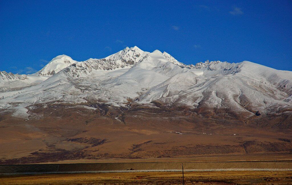 View of snow mountain range in Kham from a train to Lhasa Image source:thelandofsnows.com