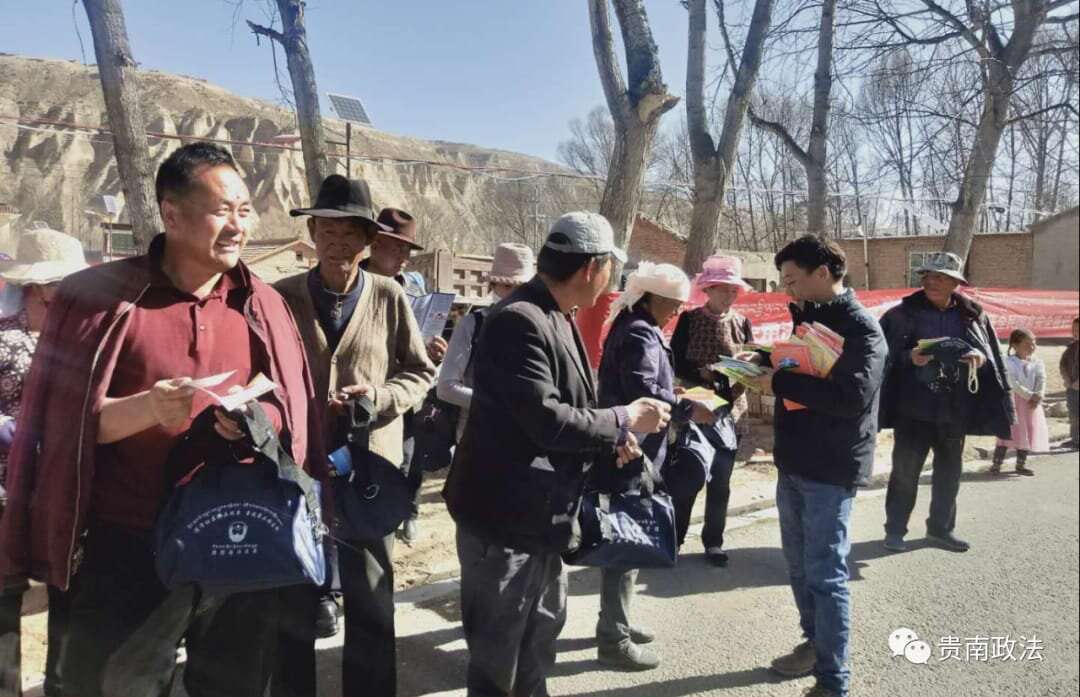 Chinese officials hand out materials to Tibetans in Mangra County.