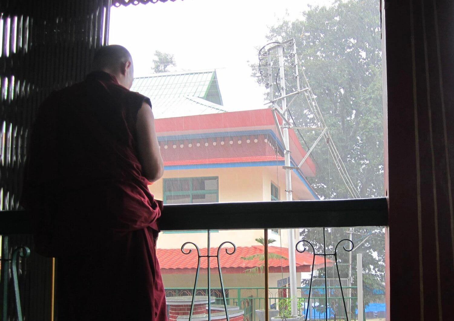 A Tibetan monk in exile waiting out the rain at the Library of Tibetan Works and Archives, Dharamsala Photo taken on 8 September 2012, Tenzin Choekyi